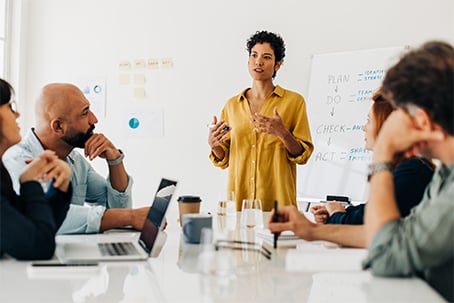 Business woman giving a speech during a boardroom meeting
